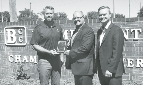 From left, Curran Vetter hands Shane Thorell a plaque thanking him for 11 years of service on the Bremer Center board of directors, eight as president. At right is Trevor Thorell, who stepped in to fill his father’s seat on the board. News-Register/Jeni Moellenberndt