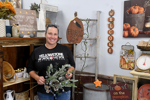 Beth Caldwell stands among her fall decor pieces in her new store Cinnamon Hearts decor and Sun Kissed Tanning in Hampton. News-Register/Jeni Moellenberndt