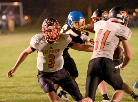 Giltner's Tanner Roth hands off to Camden Humphrey during Friday's loss to Nebraska Lutheran. 