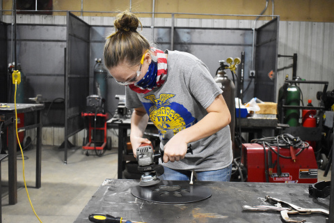 Sydney Lindburg works on a sign that she created.