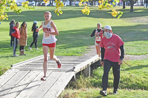 Elena Kuehner (left) holds a steady pace while Coach Zach High provides motivation.