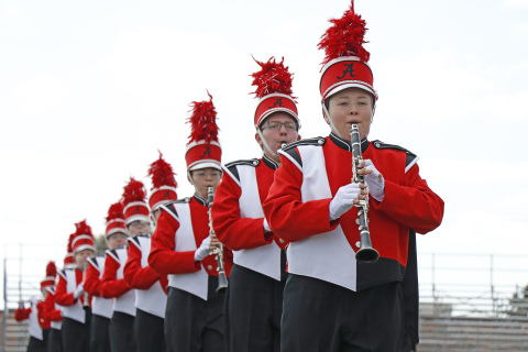 From right, Callie Gaskill, Jessica Mikkelsen, Caryn Sparks and other Aurora musicians add their clarinet sound to the Marching Huskies performance during Saturday’s marching band exhibition.