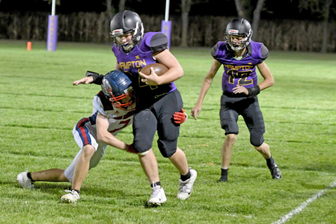 Evan Pankoke adds yards to the end of a run while teammate Landon Parsley follows the play.
