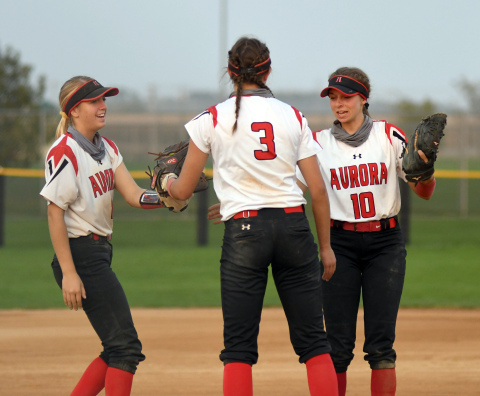 Kylie Larson (left) and Brooklyn Moody (right) send words of encouragement to Aurora pitcher Rylee Olsen during subdistrict play Monday. 