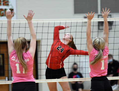 Raina Cattau splits the Hastings defense during a four-set win over the Tigers Thursday. 