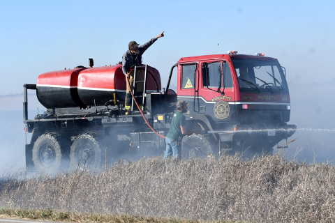 Marquette firefighters work to stop the quickly spreading fire.