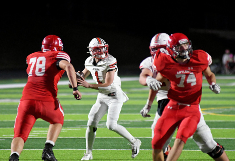 Aurora's Ethan Shaw drops back to pass during a 42-19 loss to Elkhorn in the Class B finals Friday night. 