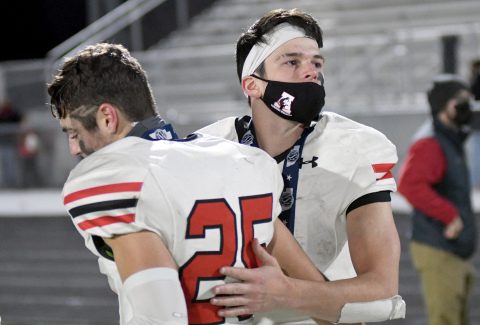 Ethan Shaw comforts fellow senior Jameson Herzberg after they each received silver medals. 