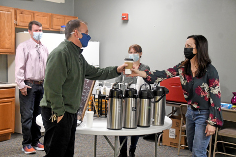Sonya Cattau serves up a special order cup of coffee to Rod Havens. In the background are foundation volunteer Rick Epp and Coasters Coffee Co. owner Sara Johnson.