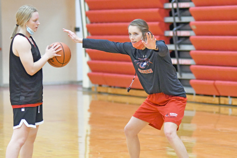 Kelly Boshart, Aurora’s new girls basketball coach demonstrates during a drill in preseason workouts ahead of Thursday’s season-opener. 