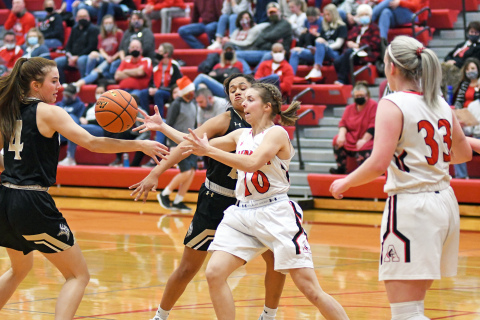 Brooklyn Moody battles for the basketball between two Grand Island Northwest defenders during Aurora’s 50-31 loss to the Vikings.