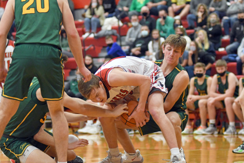 Aurora’s Cayden Phillips fights to retain possession with defenders coming from all angles during the Huskies’ 58-34 loss at home Thursday. 
