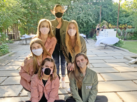 Anna Johnson, bottom left, sits with her Gamma Phi Beta sorority family at Oklahoma City University.
