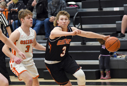 Giltner's Tanner Roth drives past an Osceola defender during a 51-37 loss Friday. 