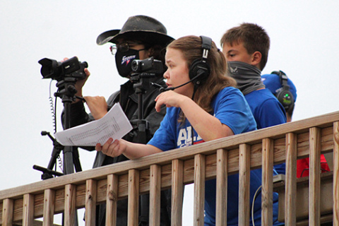Courtesy photo // Nathan Ertzner (left) and Sarah Person work together to capture both audio and video during an HPC football broadcast last fall.