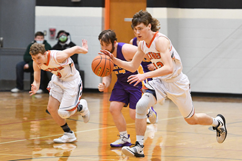 Giltner senior Camden Humphrey is off to the races on a fastbreak, with teammate Nate Leichty and Hampton defender Jake Arndt following the play.
