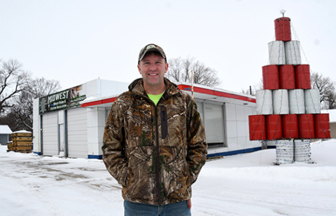 Eric Joseph stands in front of the Highway 34 structure where he currently bases his Midwest Spray Foam business. Joseph is planning to tear down the former gas station when the weather allows and build a new structure in its place.