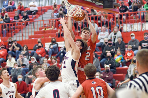 Aurora’s Tate Nachtigal battles near the bucket during the Huskies’ 53-38 loss to Adams Central in the CC finals. 