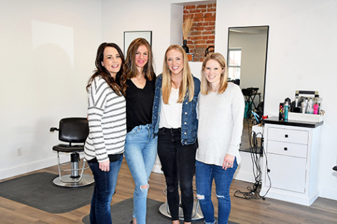 Anya Griffith, pictured at right, is the new owner of Hometown Roots Salon, which opened March 8 on the southeast corner of the downtown square. Pictured with her, from left, are employees Joni Retzlaff, Jessica Clark and Keri Hastings. Note the exposed brick in the background, reflecting the historic nature of the renovated structure.