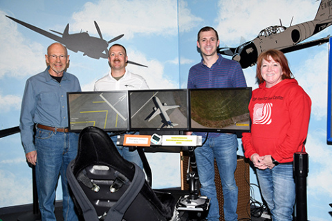 Pictured from left, Aurora pilots Dr. John Wilcox, Keal Bockelman and Brett Mitchell have agreed to share their aviation experience during the Edgerton Explorit Center’s first-ever air academy beginning June 28. At right is Mary Molliconi, the center’s executive director.
