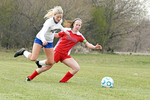 Aurora’s Raina Cattau plays tough defense on the backline during Aurora’s 5-0 win over Seward Thursday