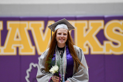 Abbey Arndt has reason to smile as she walks out of the Hampton gymnasium Saturday as a Hawk graduate.