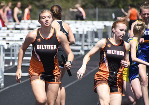 The Giltner girls 3200 relay completes a handoff.