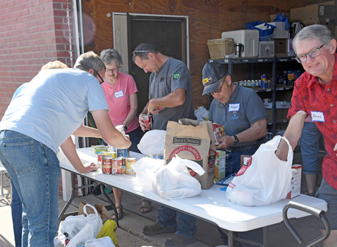Volunteers collect food items Tuesday morning at the Hamilton County Food Pantry.