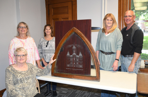 Members of the Courthouse 125th Anniversary Committee pictured with an old window from the courthouse etched with a special logo include, from left: Karen Bamesberger, Becky Richter, Nancy Thomas, Tina and Bill Anderson. Not pictured are Scott Stuhr and Nancy Salmon