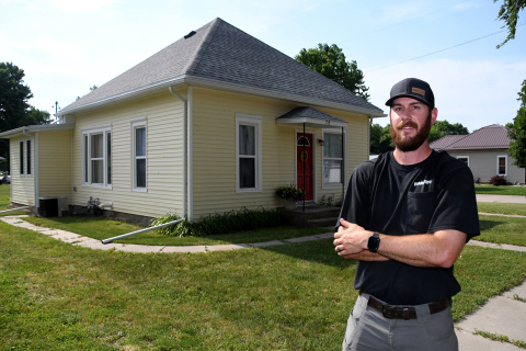 Nic Lewis is shown outside “Sunflower Cottage” on H Street in Aurora, which debuted on Airbnb as a local housing option in April. 