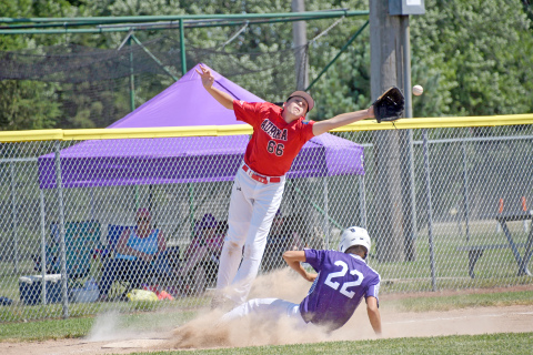 Aurora Cooperative Juniors third baseman Booker Scheierman stretches all the way out for a throw down to third during Aurora’s loss to Wood River Sunday. 