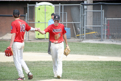 Jayson Havens (right) fist pumps Cayden Phillips during Aurora’s 9-1 win over Crete. 