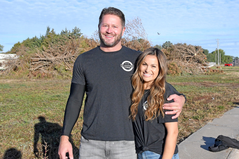 Todd and Teresa Vettel stand on the Highway 34 and 5th Street site which will soon be the location of a Scooter’s Coffee. Vettel and his two brothers, Tim and Trevor, were born in Aurora and spent their early childhood years here.