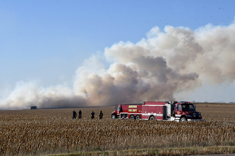 Aurora firefighters on the scene of a field fire Tuesday near Marquette.