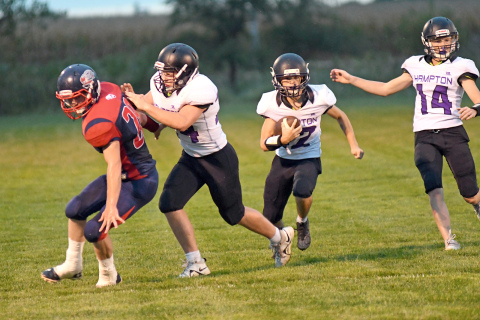Evan Pankoke clears the runway for Justin Gyhra toward the end zone during Hampton’s 58-18 win at Heartland Lutheran Friday night. 