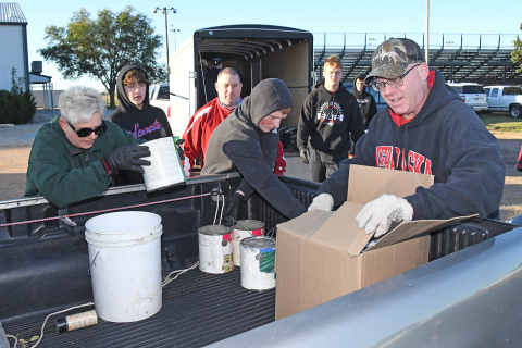 Denise McGovern-Gallagher, left, with Grand Island Area Clean Community Systems, works with Rotary and Aurora football volunteers to sort and load up various hazardous waste materials brought to the fairgrounds Saturday morning.