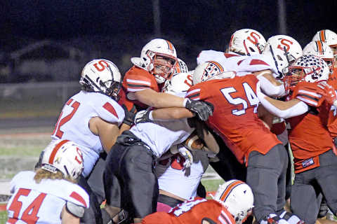 Aurora’s defense held Scottsbluff to 206 total yards Friday night, highlighted by multiple defenders to the ball, like Jack Allen (middle) and Kellen Peterson (54). 