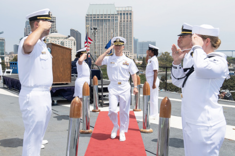 U.S. Navy photo courtesy of Mass Communication Specialist 2nd Class Zachary Pearson // Capt. Joshua Nauman is piped ashore following a change of command ceremony on the flight deck of the USS Midway Museum in July of this year.