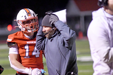 Bryce Barger celebrates with coach Kyle Peterson as the Huskies turned away Omaha Skutt on the game’s final possession. 