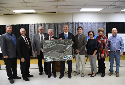 Pictured from left are Cliff Messner of Central City; Aurora Mayor Marlin Seeman; Dist. 34 Sen. Curt Friesen; Dist. 36 Sen. Matt Williams; Gov. Pete Ricketts; home builder Brock Henderson; Jannelle Seim, president of the Aurora Housing Development Corporation; Kelly Gewecke with the Nebraska Department of Economic Development; and Hamilton County Board commissioner John Thomas.