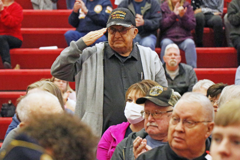Aurora veteran Stan Wilshusen stands at attention as Aurora band plays each military branch’s song.