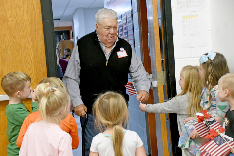 Local veteran Jerry Hinrichs is presented a small American flag by Giltner’s preschool class before the annual Veterans Day Program Nov. 10.