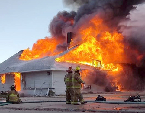 Aurora firefighters monitor Sunday's control burn of the golf course clubhouse.