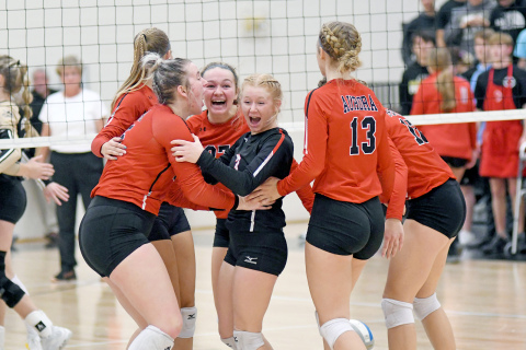 Aurora celebrates a rally during a four-set loss to GINW in the B-6 district final contest Saturday. 