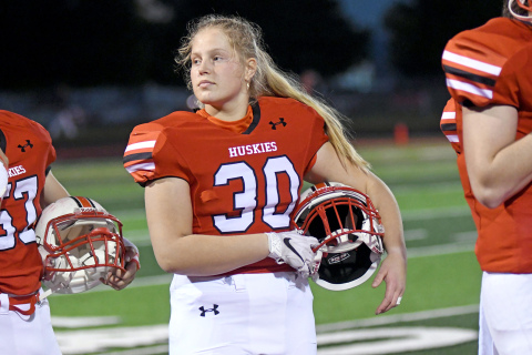 Tia Teigre, a foreign exchange student from Norway, stands in formation as the Aurora band plays the National Anthem before the Lexington game Friday. 