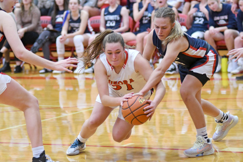 Rylee Olsen battles for the ball down to the floor in the first half of Aurora’s 51-28 win on opening night Thursday.