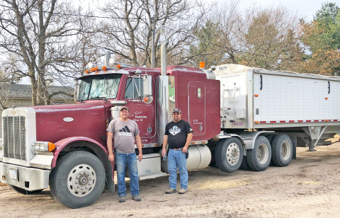 Eric Kothe, left, and Brad Consbruck were among the neighbors helping in a Nov. 15 harvest bee. Also helping were Ron and Gene Consbruck.
