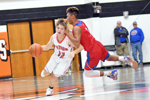 Giltner’s Cooper Reeson dribbles around HPC’s Mario Lesiak, who got a bit off balance in the air.