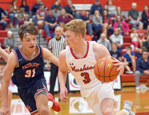 Drew Knust dribbles past an Adams Central player during Aurora's 45-33 win over the Patriots. 