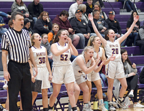 Hampton’s bench celebrates after a made bucket during the second half of its 52-36 win over rival Giltner on senior night Friday. 